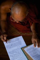 Monk master writing in his journal
